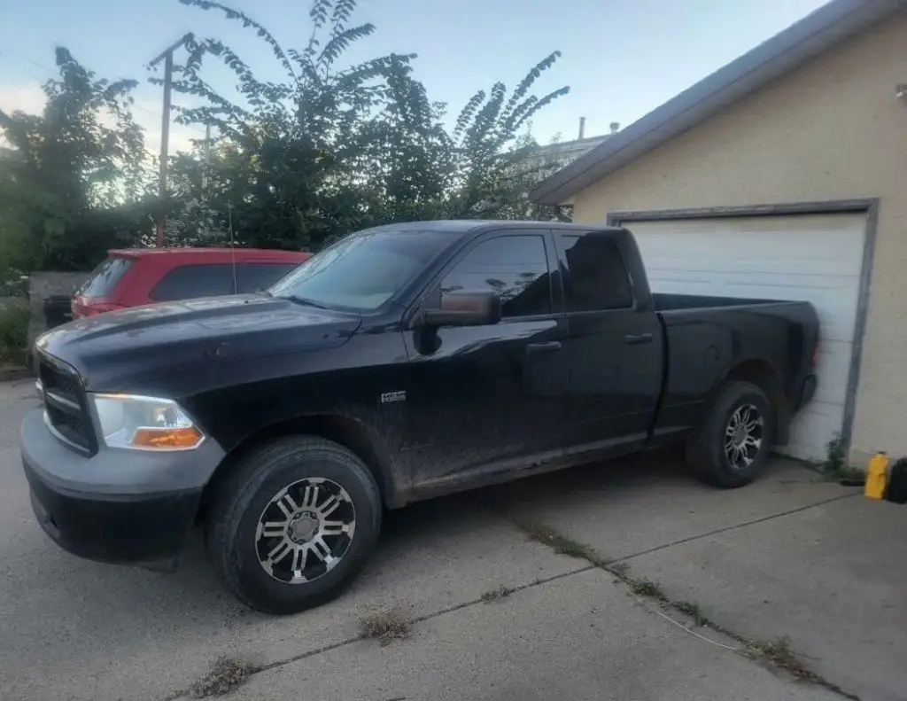 a black truck parked in a driveway